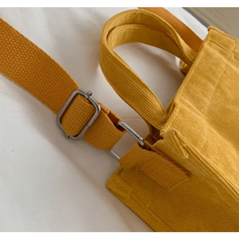 Yellow bag with strap and buckle on a white background